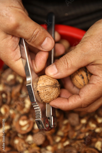 Man cracking walnuts with m...