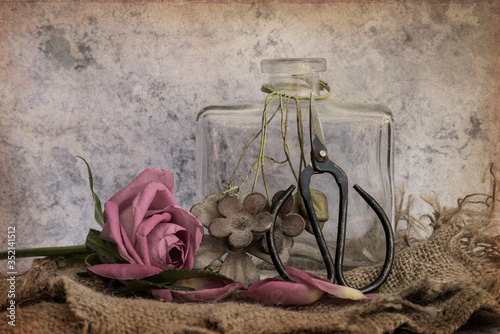 Romantic vintage retro look applied to flower and garden paraphenalia still life image with Spring and Summer seasonal blooms