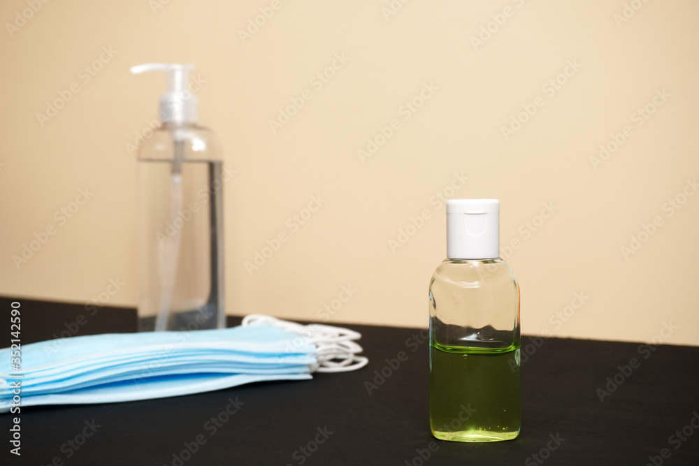 Coronavirus prevention medical surgical masks and hand sanitizer gel for hand hygiene corona virus protection. Healthcare and medical concept. Coronavirus prevention medical surgical masks and hand sanitizer gel for hand hygiene corona virus protection. Healthcare and medical concept.