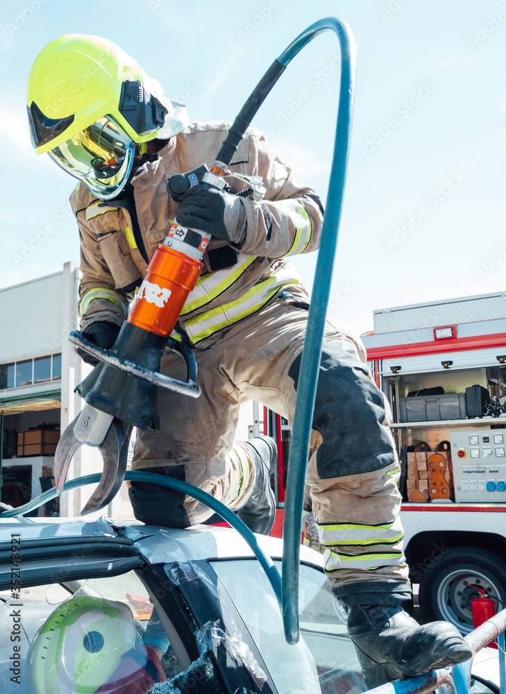 Firefighting Car Scissors Firefighter climbed on top of the vehicle using rescue tool to cut ...