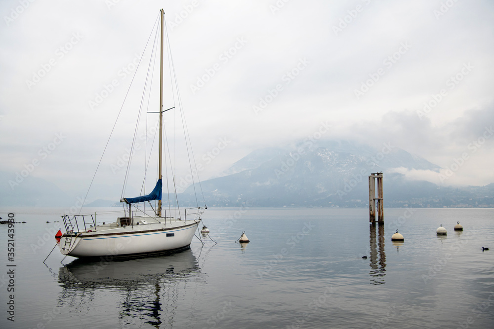 White sailing yacht on lake Como. Water sports. The concept of a luxurious lifestyle and outdoor activities.