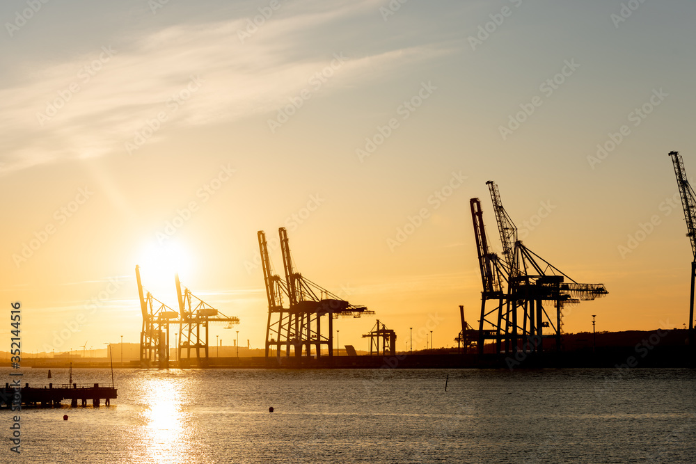 Large ship to shore container cranes at sunset