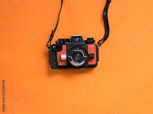 vintage photo camera on orange background