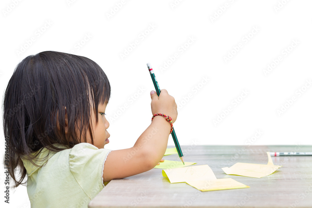 Selective focus. Portrait image of 2-3 yeas old child girl. Asian student writing with a pencil on the paper in the room. Study from home, social Distance, Kid and education concept. Selective focus. Portrait image of 2-3 yeas old child girl. Asian student writing with a pencil on the paper in the room. Study from home, social Distance, Kid and education concept.