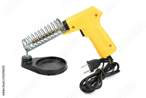 Yellow electrical solder on soldering iron stand isolated on a white background with clipping path.