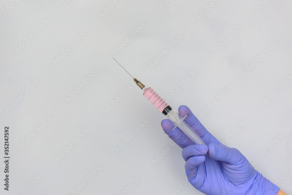 Close up hand in medical gloves holding syringe isolated on white background with copy space. Medicine and vaccination concept. Close up hand in medical gloves holding syringe isolated on white background with copy space. Medicine and vaccination concept.