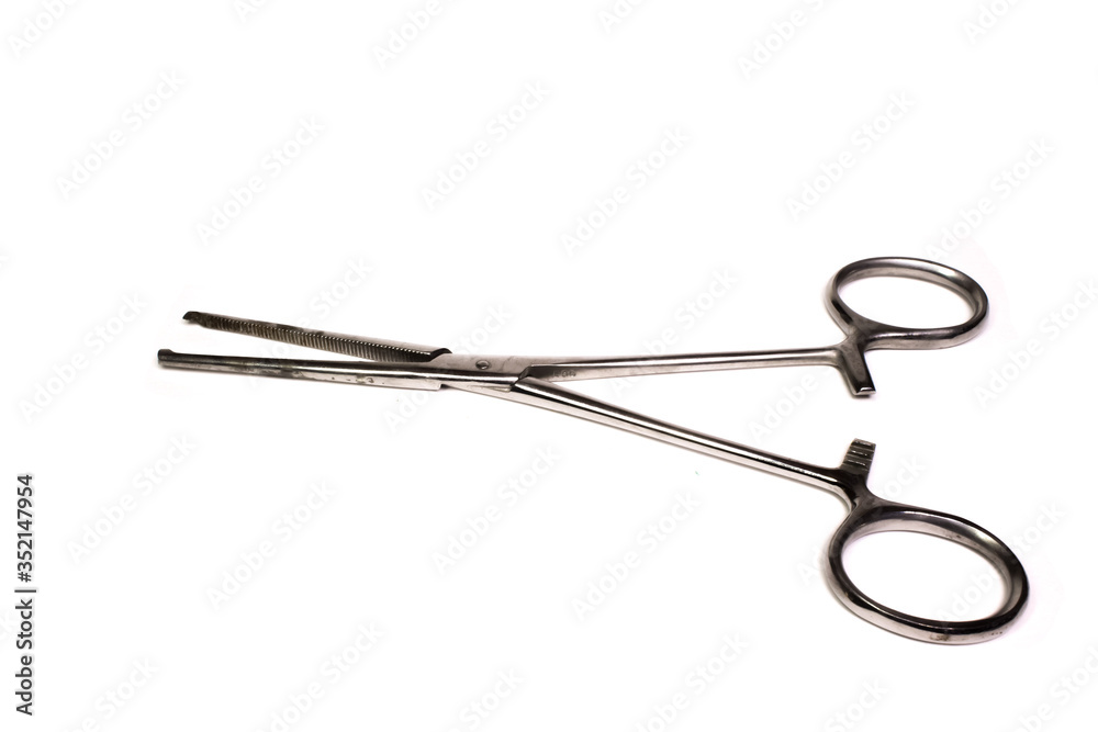 The medical clamp in the open is on a white background. The medical clamp in the open is on a white background.