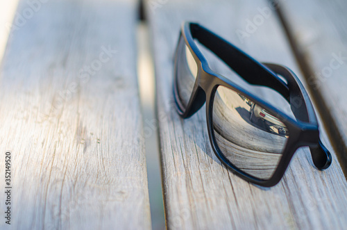 sunglasses are on the bench by nikon d5100 photo