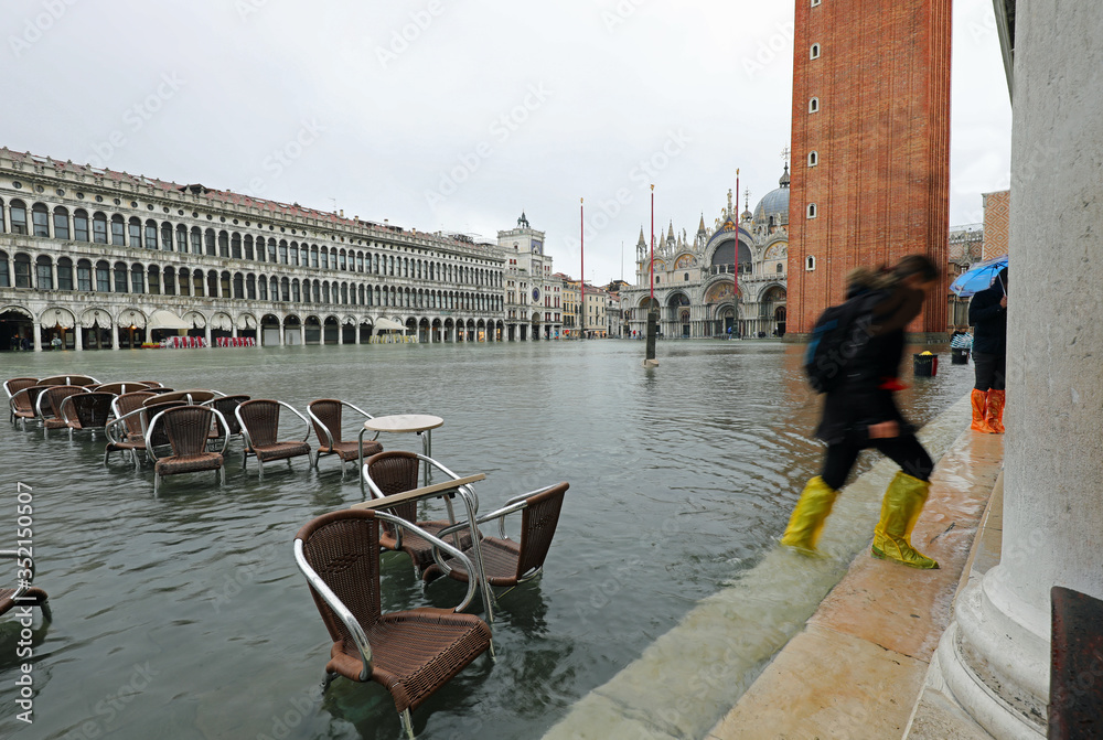 Chairs of an alfresco cafe in the fully flooded Square of Saint