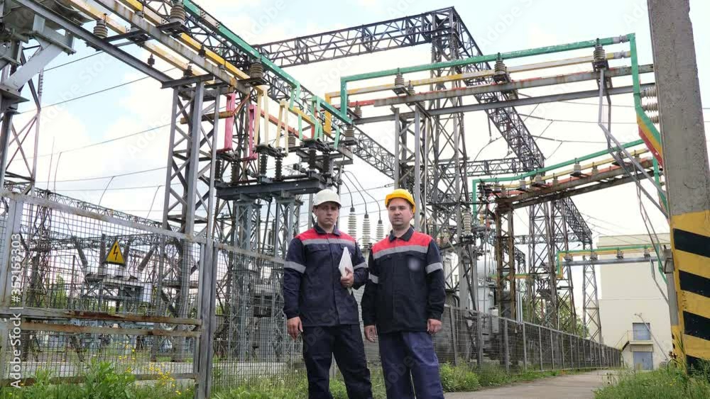 Two engineer working on checking and maintenance equipment of the substation. Power engineering Two engineer working on checking and maintenance equipment of the substation. Power engineering