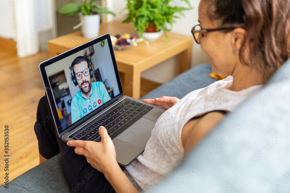 Woman at home on a video call with man - happy couple talking at seeing each other during quarantine and self isolating - Friends and families using technology to reduce distance Woman at home on a video call with man - happy couple talking at seeing each other during quarantine and self isolating - Friends and families using technology to reduce distance