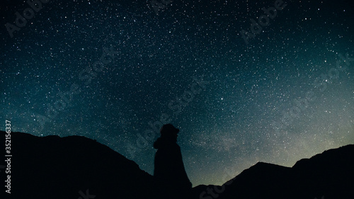 winter landscape with mountains. landscape with stars. man on the background of stars