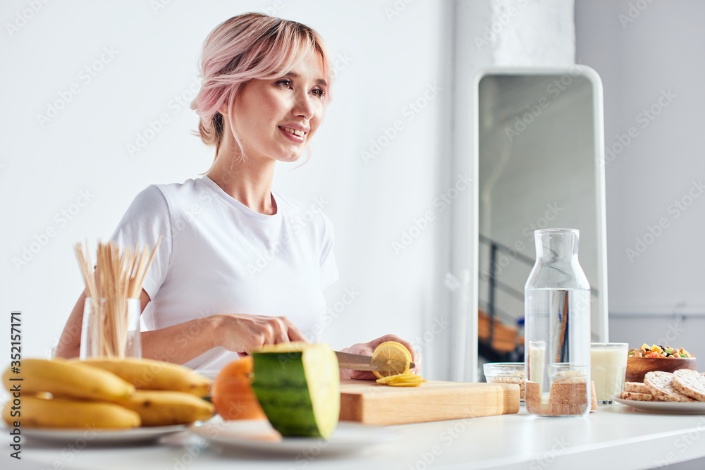 Woman cooking in bright studio