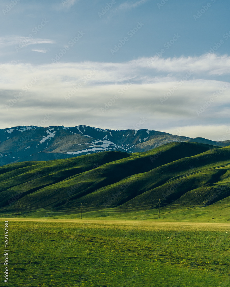 Snowy ridge. Altai mountains. Siberia. beautiful valley with green grass and mountains