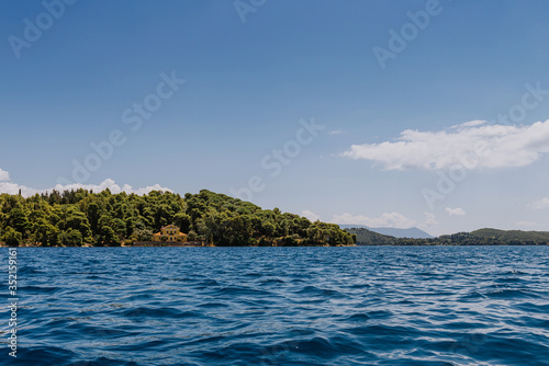 Small uninhabited tropical island in the ocean.