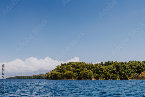 Greek Island viewed from the sea. Beautiful sea landscapes on Island in Greece. In distance is famous Scorpios island, from the left side is Lefkada island and from right is a part of gorgeous © andreiko