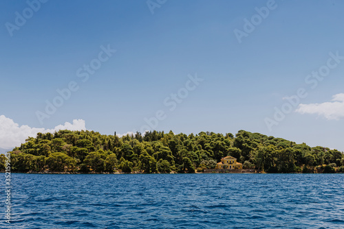Greek Island viewed from the sea. Beautiful sea landscapes on Island in Greece. famous Scorpios island, from the left side is Lefkada island and from right is a part of gorgeous Meganisi island. © andreiko