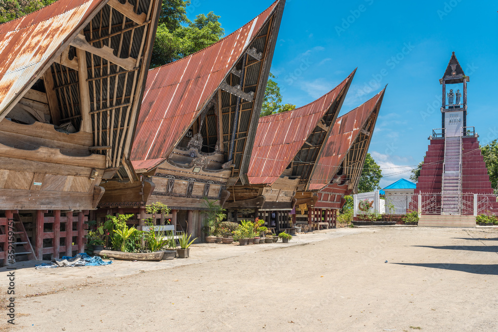 Traditional Batak Village of the Siti Clan. The houses called Rumah Bolon or Jabu, are noted for their distinctive roofs which curve upwards at each end, as a boats hull does and their carving decor