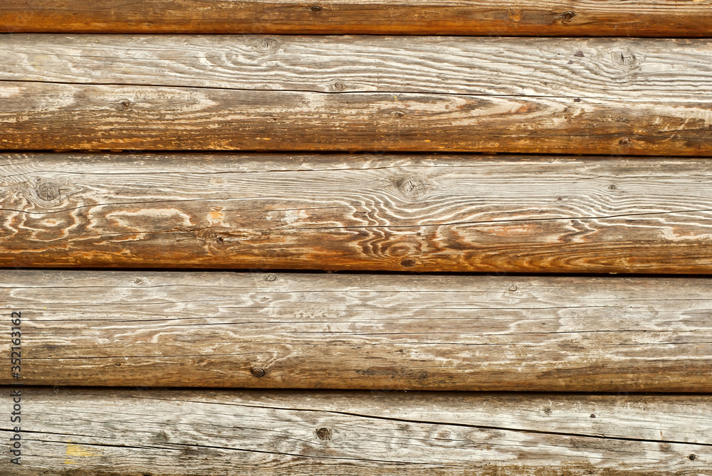 Old distorted boards in a row on the wall. Texture of natural rough boards. Old distorted boards in a row on the wall. Texture of natural rough boards.