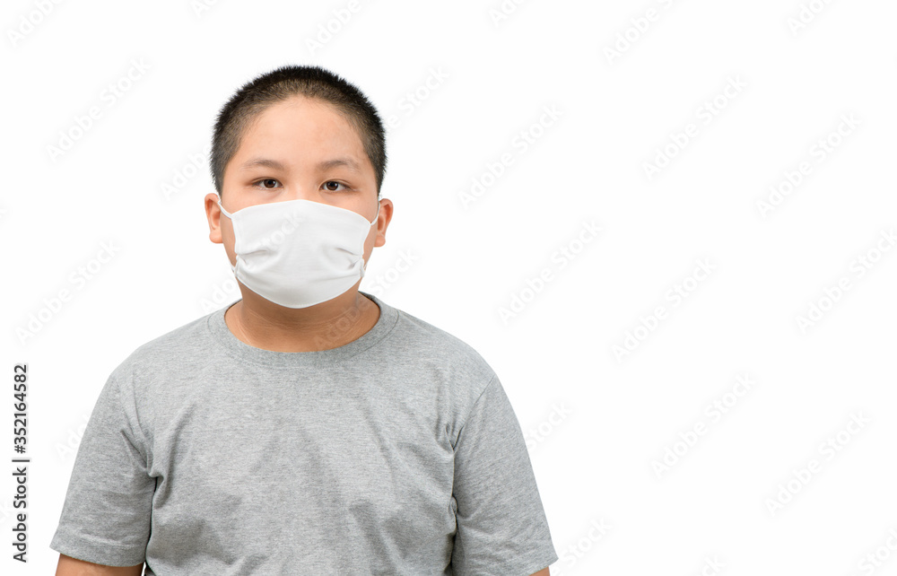 Asian obese boy wearing a protective mask to protect coronavirus outbreak Asian obese boy wearing a protective mask to protect coronavirus outbreak
