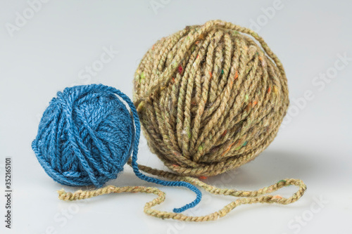 two balls of yarn, blue and beige