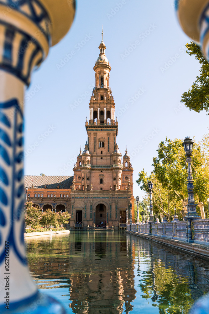 Tower of Spain Square in Seville reflected in the water