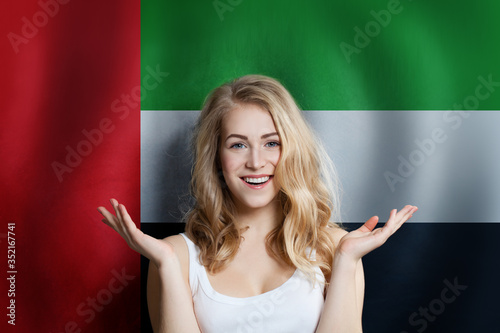 Arabic concept with happy Surprised cute girl with UAE flag background. Travel and education concept photo