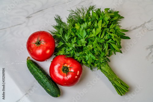 Fresh vegetables. parsley, cucumber, dill, tomato on a white background.