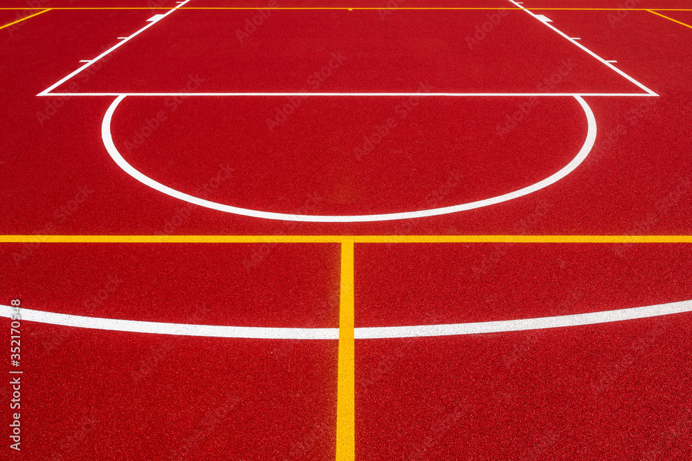 Red background of newly made outdoor basketball court