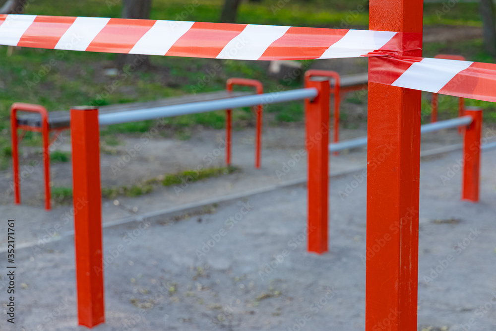 losed sport ground space by red white striped limit tape in pandemic corona virus quarantine losed sport ground space by red white striped limit tape in pandemic corona virus quarantine