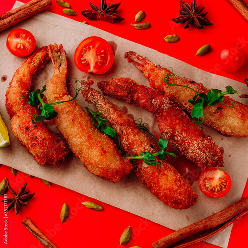 Asian food, with seafood and sauce, on a red background