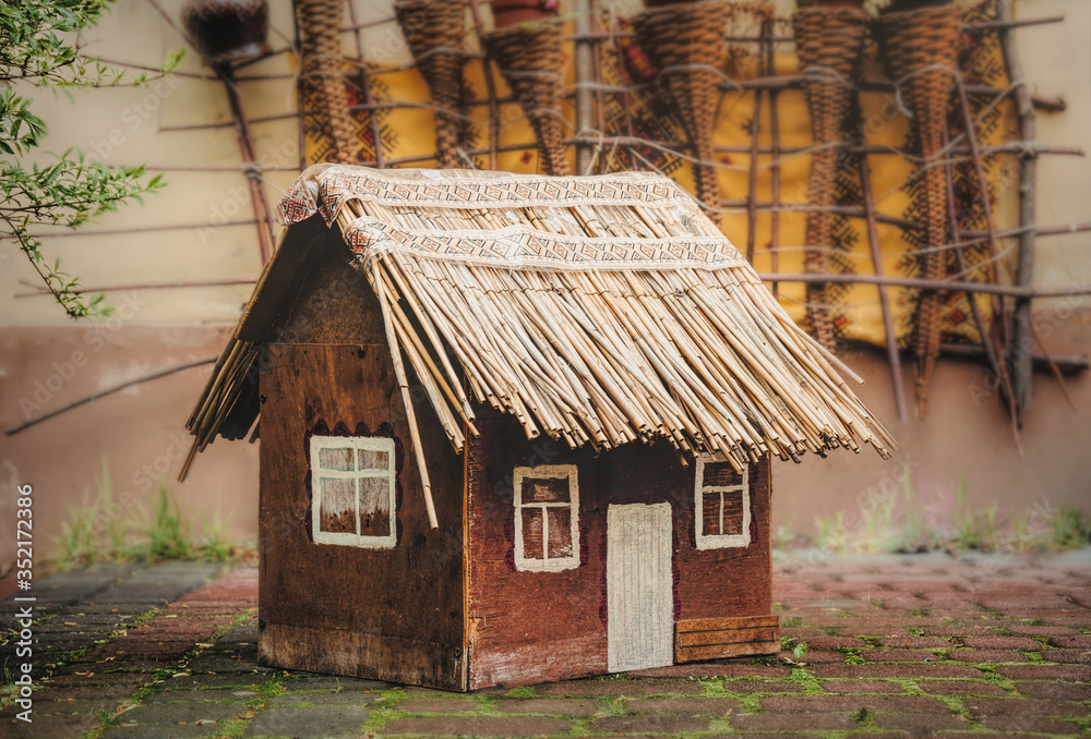 Toy wooden house with a thatched roof Toy wooden house with a thatched roof