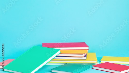 Pile of colorful books and notebooks. Education, study, learning, back to school, teaching concept. Stop motion animation