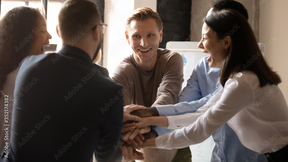 Teamwork Engaged Excited diverse business people stacking hands at corporate meeting ...