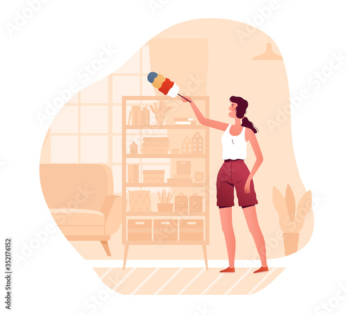 A young woman wipes dust from a cabinet at home in the living room. The concept of homework and daily cleaning