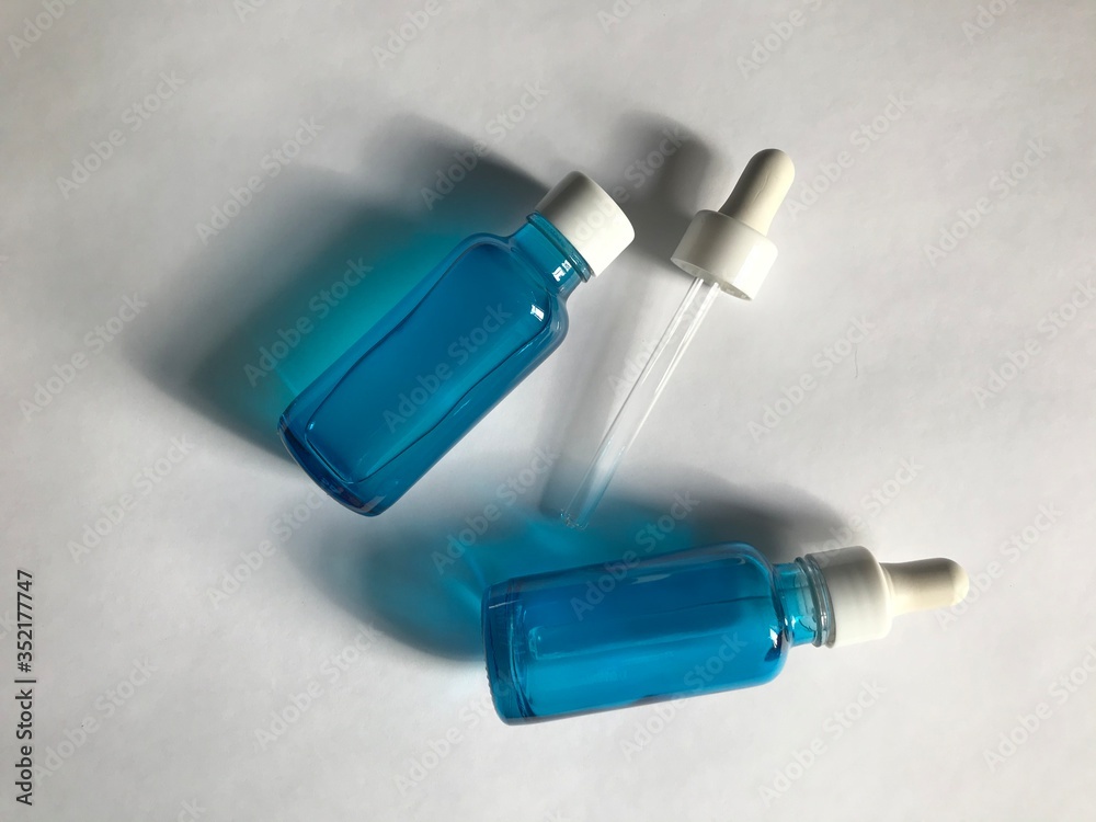bubble with serum and a dropper in the sunlight. cosmetics for care bubble with serum and a dropper in the sunlight. cosmetics for care