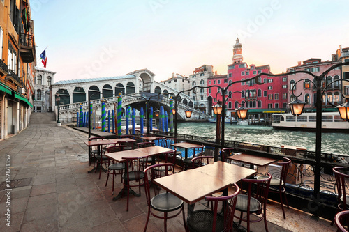 Venice in Italy - Rialto Bridge and Grand Canal with empty embankment, tourist centre of famous city without people