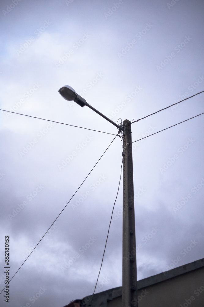 lamppost with cloudy sky and cables lamppost with cloudy sky and cables