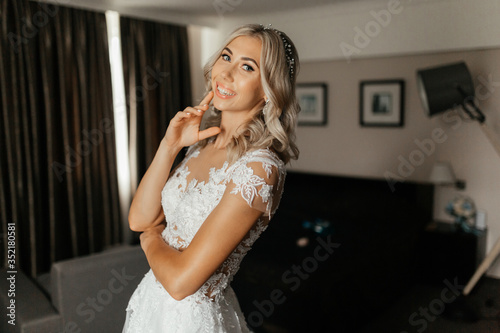 Smiling blonde woman in the wedding dress