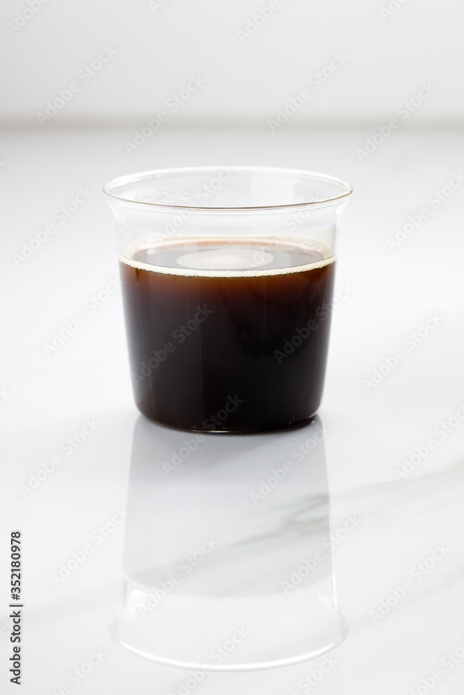 cup of hot coffee on white marble table background. cup of hot coffee on white marble table background.
