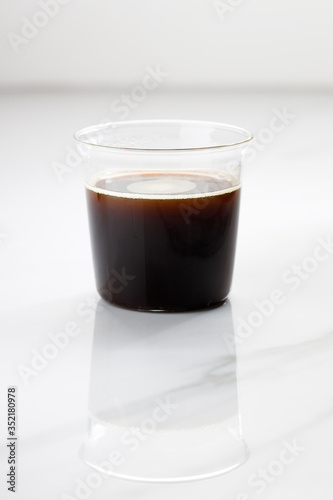 cup of hot coffee on white marble table background.