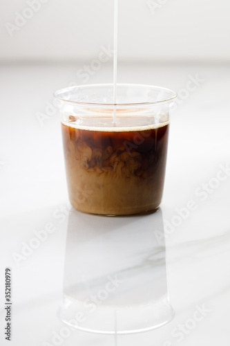 cup of hot coffee on white marble table background.