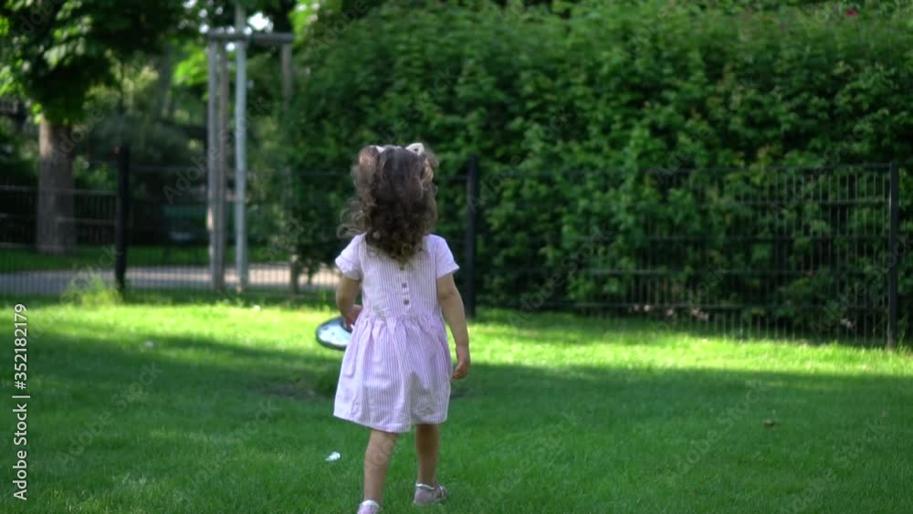 little girl walking in the park slow motion little girl walking in the park slow motion