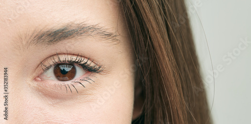 Beautiful eye, close-up of a Caucasian girl who smiles sweetly.
