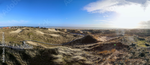 North Sea dunescape panoramic view in Amrum island with view of Wittduen village