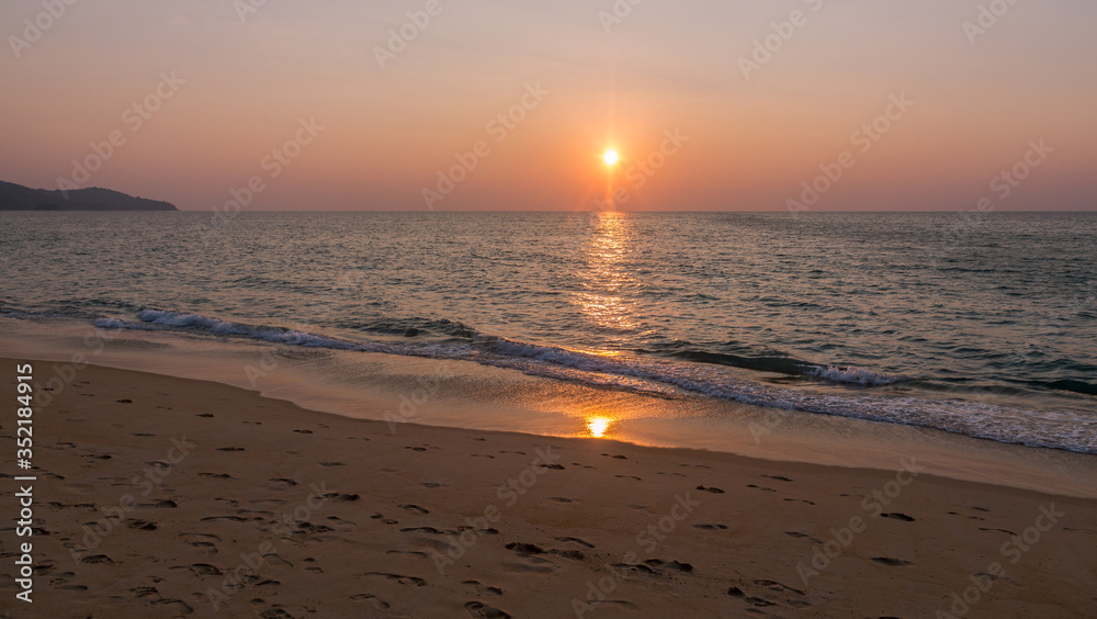 Sunset and reflection of sun on a beach - Phuket / Thailand