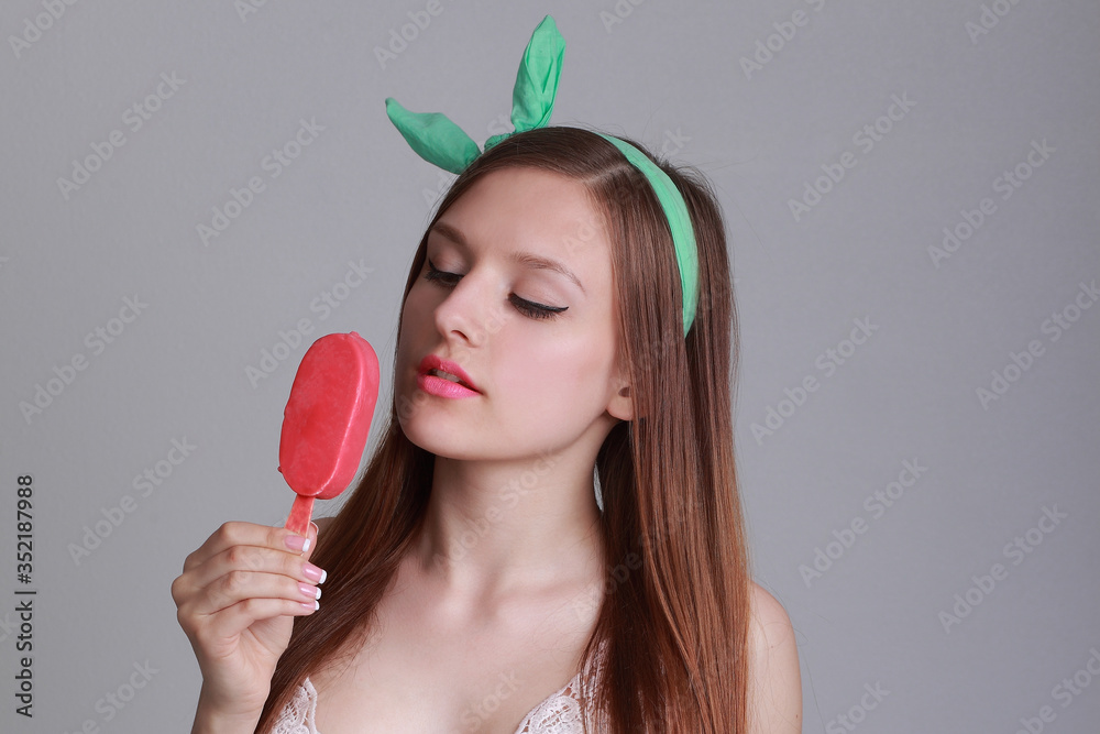 young beautiful woman eats icecream in studio young beautiful woman eats icecream in studio
