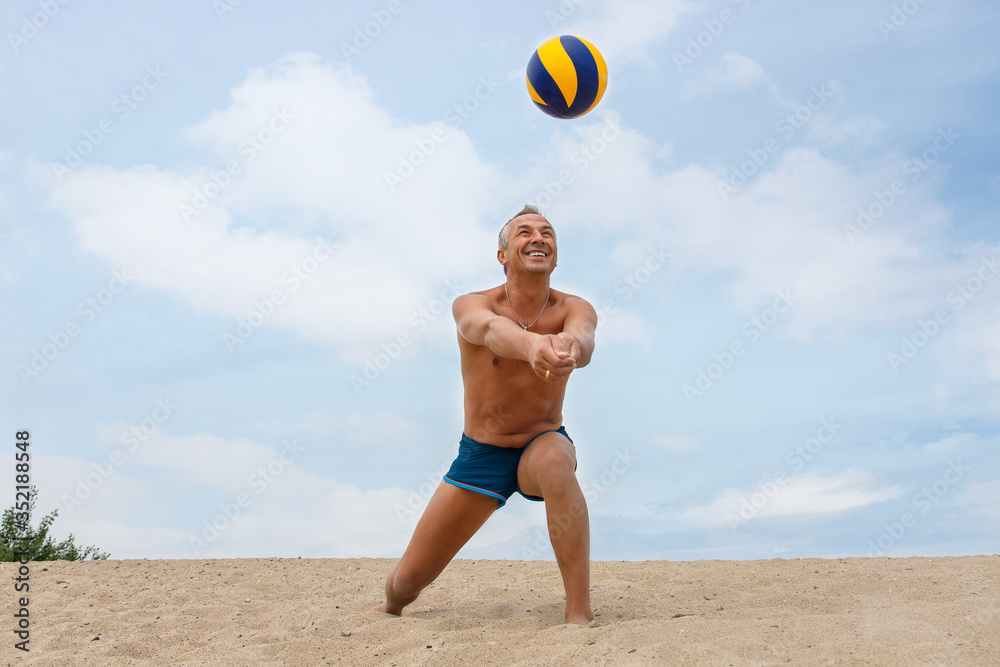 man playing volleyball on beach