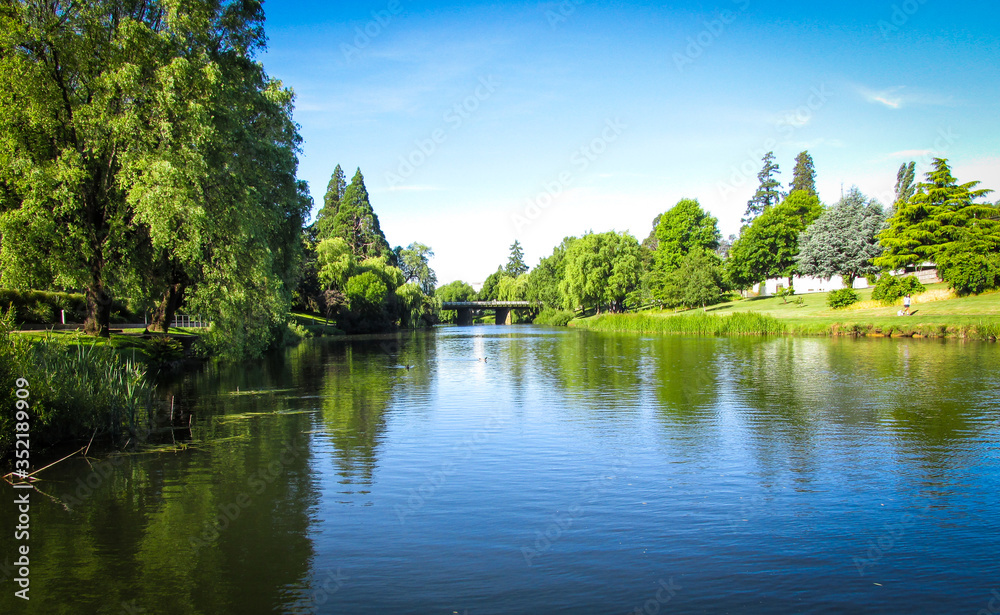 View of Meander River with The Meander River Bridge in the distance. Taken in Deloraine, a tourist destination town because of its proximity to the surrounding Tasmanian natural attractions 