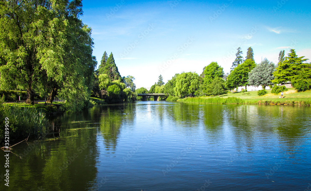 View of Meander River with The Meander River Bridge in the distance. Taken in Deloraine, a tourist destination town because of its proximity to the surrounding Tasmanian natural attractions View of Meander River with The Meander River Bridge in the distance. Taken in Deloraine, a tourist destination town because of its proximity to the surrounding Tasmanian natural attractions